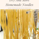 Homemade noodles hanging on a noodle drying rack.
