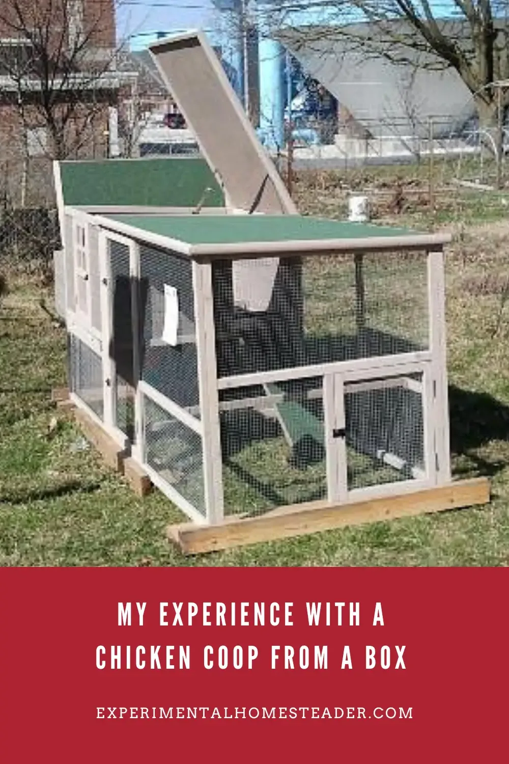 A chicken coop with the top open sitting outside.