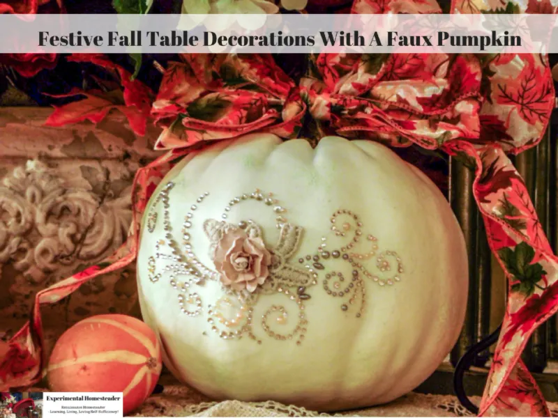 A white pumpkin decorated with a bow and bling.
