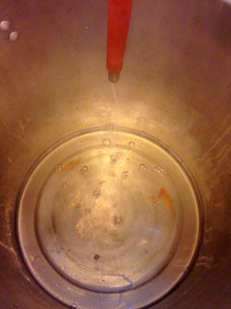 Pure tomato juice being extracted from the tomato pulp.