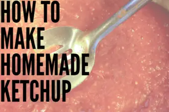 Homemade ketchup in a stainless steel pan being stirred.