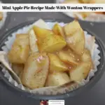A mini apple pie recipe in a wonton wrapper inside a cupcake wrapper in a muffin tin.