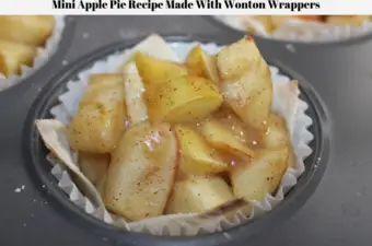 A mini apple pie recipe in a wonton wrapper inside a cupcake wrapper in a muffin tin.