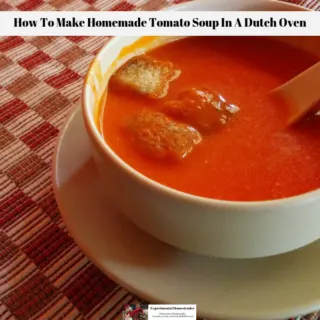 A bowl of freshly made tomato soup with croutons in a bowl on a table.