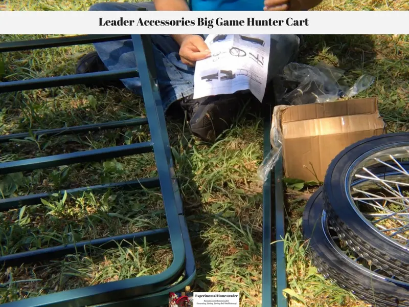 Pieces of the game hunter cart laying on the ground and Jeffrey holding the assembly instructions.