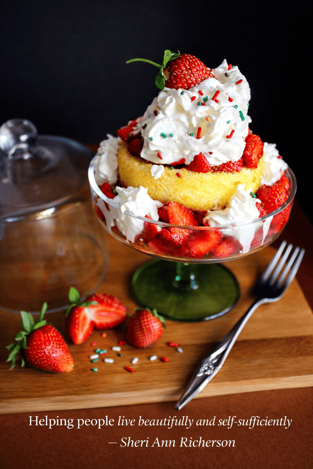 Homemade strawberry shortcake layered with fresh strawberries, whipped cream, and cake, served in a glass dessert dish.