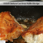 This photo is of browned fried chicken breasts in a cast iron skillet.