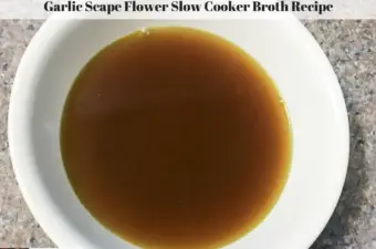 Broth made with garlic scape flowers in a bowl.