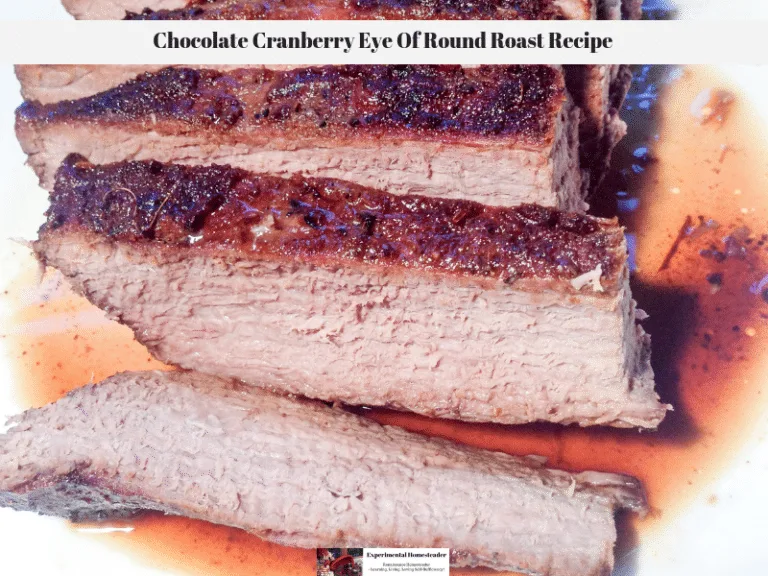 The chocolate cranberry eye of round roast sliced and resting on a plate.