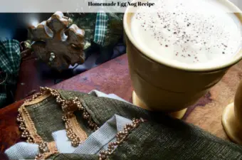A cup of homemade eggnog sitting on a table.