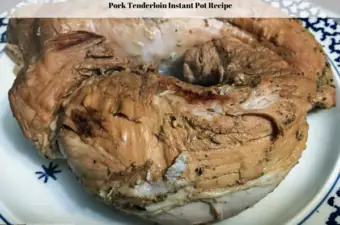 A cooked pork tenderloin on a plate.