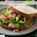 Tuna salad sandwich on a plate.