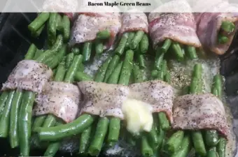 Bacon wrapped maple green beans, wrapped with a dash of butter on top ready to go into the oven to bake.