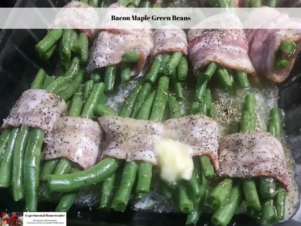 Bacon wrapped maple green beans, wrapped with a dash of butter on top ready to go into the oven to bake.