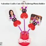 The completed tabletop photo holder with photos in it.