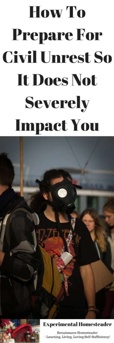 A woman in a gas mask and other people standing around her facing away from the camera.