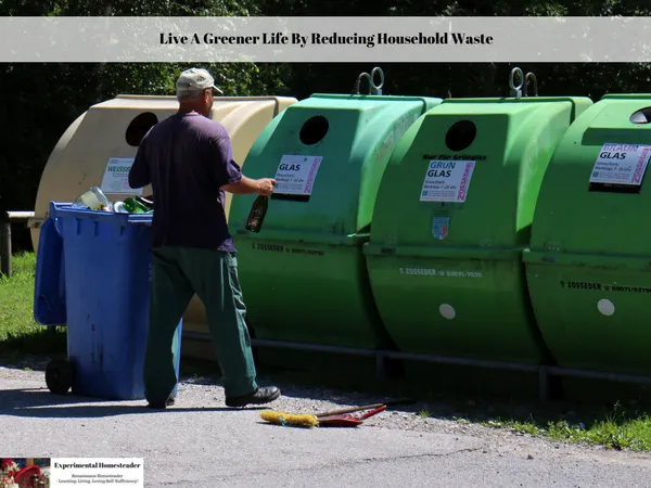 A man in front of recycle bins with his trash can filled full of recyclable material.