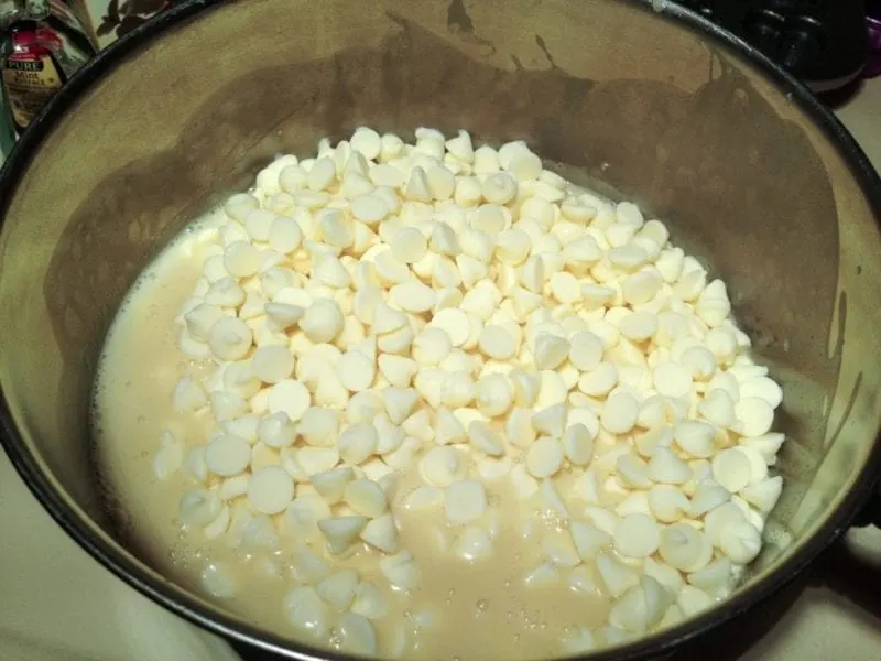 The white chocolate being added to the pan.