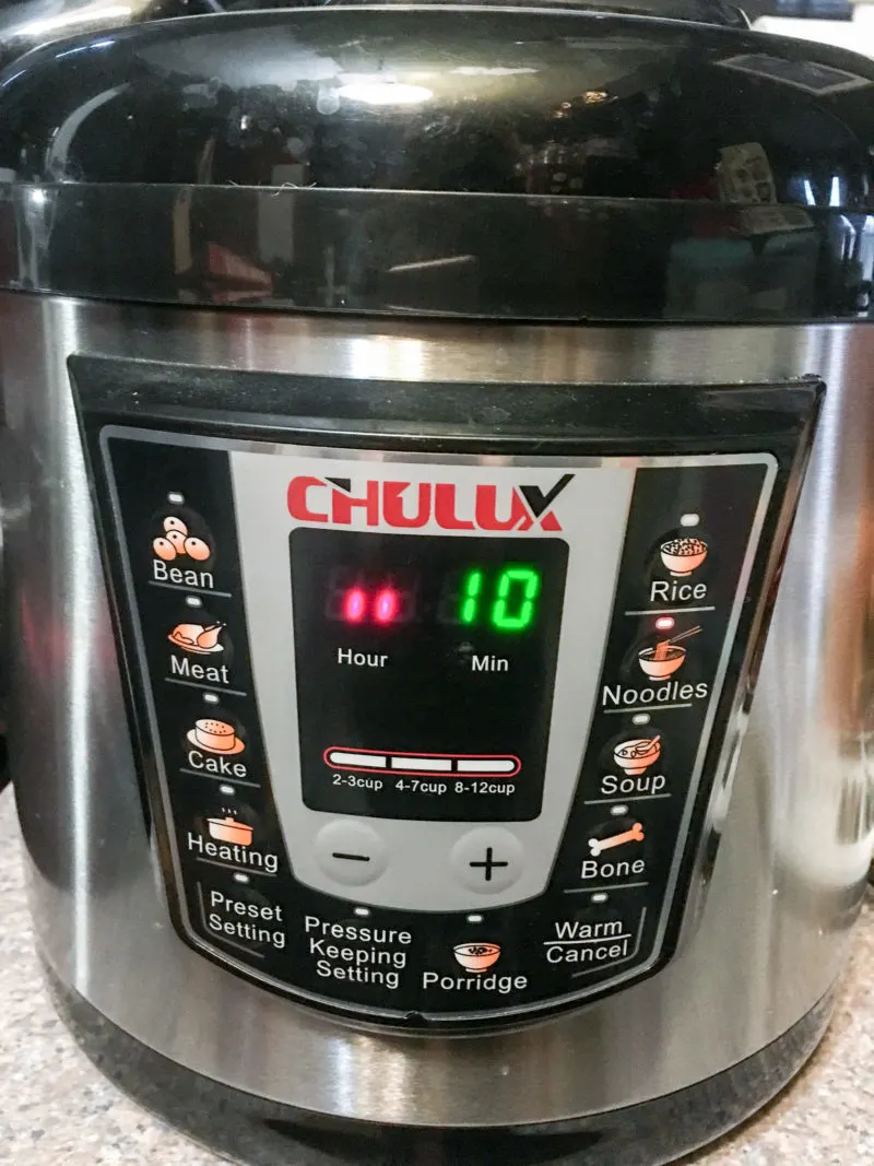 An Chulux Brand Electric Pressure Cooker sitting on a counter.