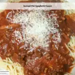 Cooked spaghetti on plate topped with homemade spaghetti sauce and freshly grated parmesan cheese.
