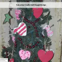 An evergreen tree decorated with heart shaped ornaments and red beads.