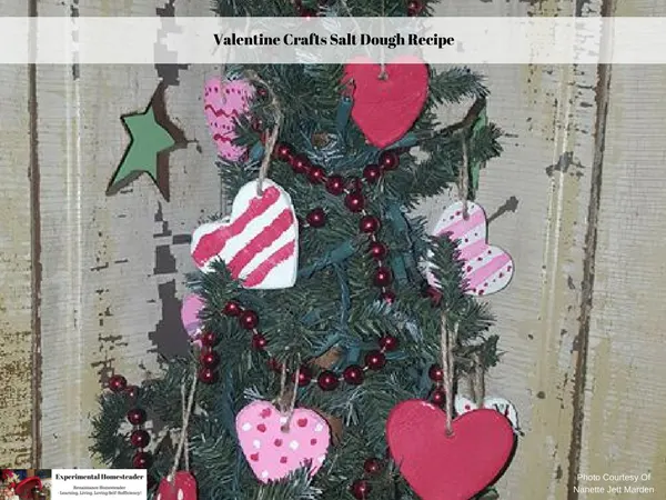 An evergreen tree decorated with heart shaped ornaments and red beads.