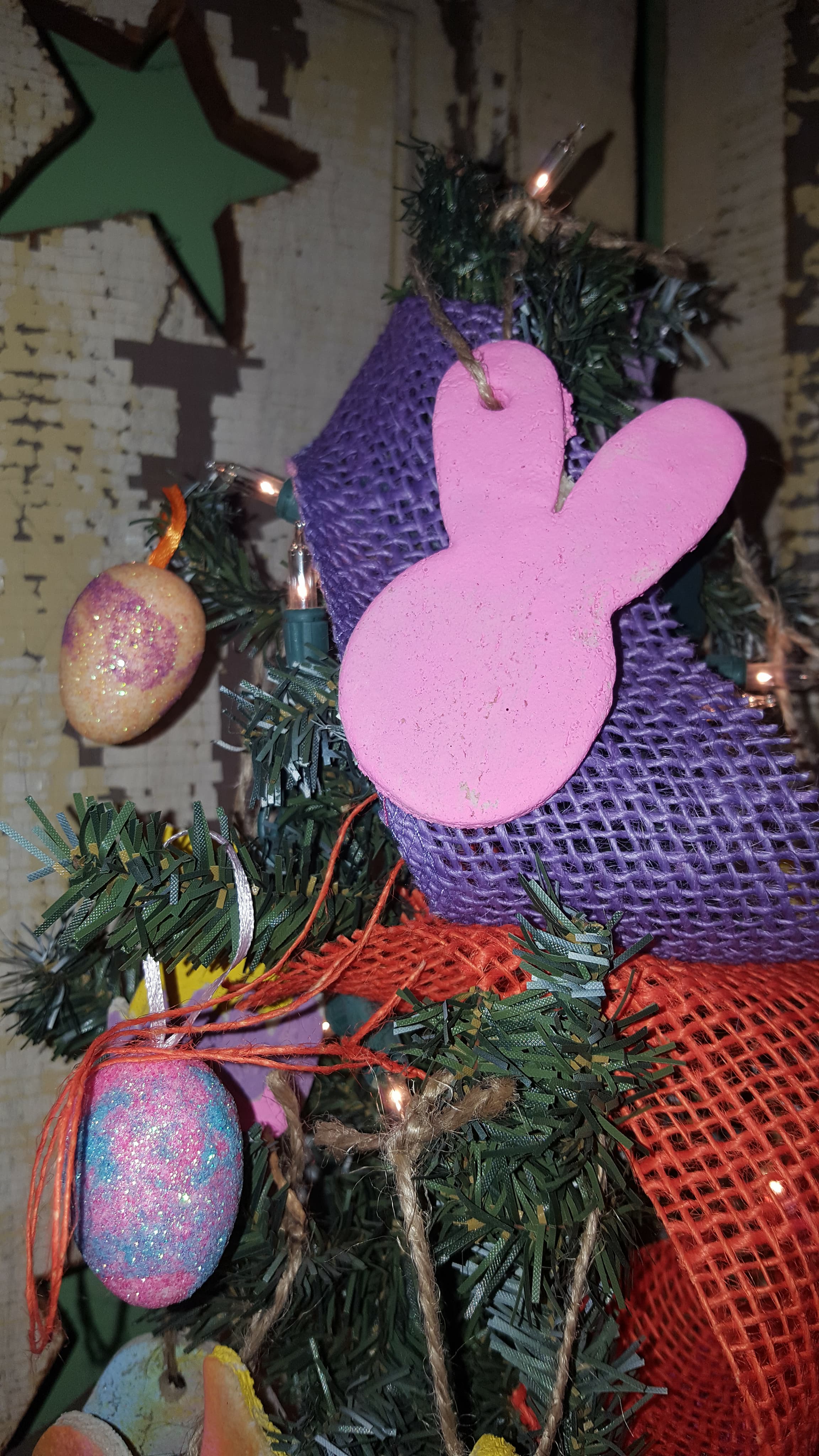 A primitive Easter tree decorated with handmade salt dough ornaments, fake Easter eggs and colored burlap.
