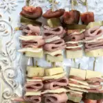 Ham kabobs on a plate.