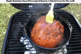 Frick's Super Trim Bone-In Ham With Natural Juices being glazed with a maple bourbon glaze and cooked in a cast iron Dutch Oven on a charcoal BBQ grill.