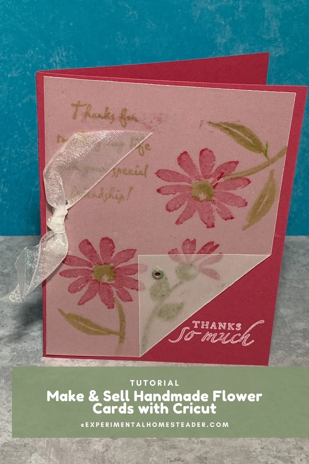 Handmade pink and red flower greeting card with ribbon bow and vellum overlay.