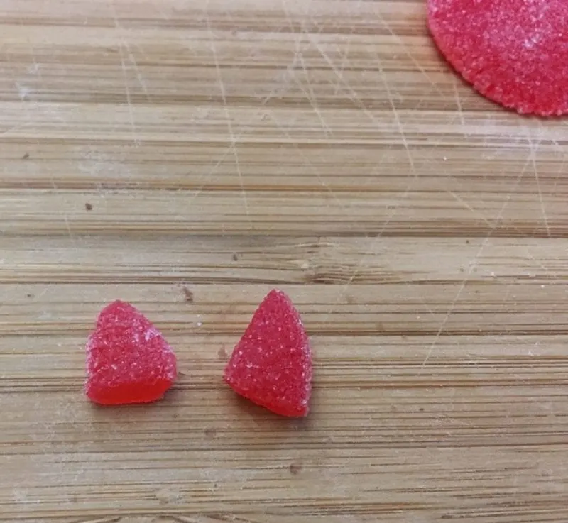 A red spice drop cut into triangles