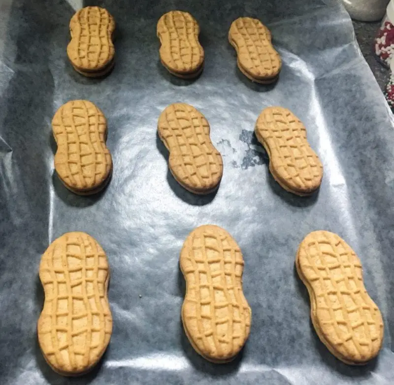 Nutter Butter Cookies laying on a piece of wax paper.