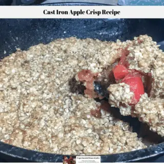 A slice of the apple crisp being removed from the cast iron skillet.