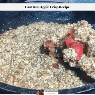 A slice of the apple crisp being removed from the cast iron skillet.
