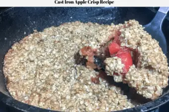 A slice of the apple crisp being removed from the cast iron skillet.