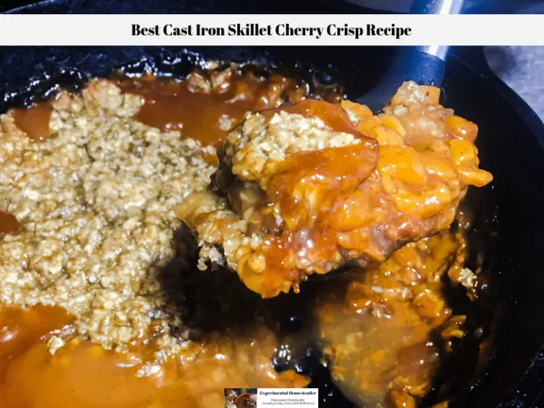 Cherry crisp being dipped out of a cast iron skillet.