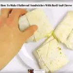 Healthy flatbread sandwiches with basil and cheese being picked up off a plate.