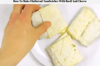 Healthy flatbread sandwiches with basil and cheese being picked up off a plate.