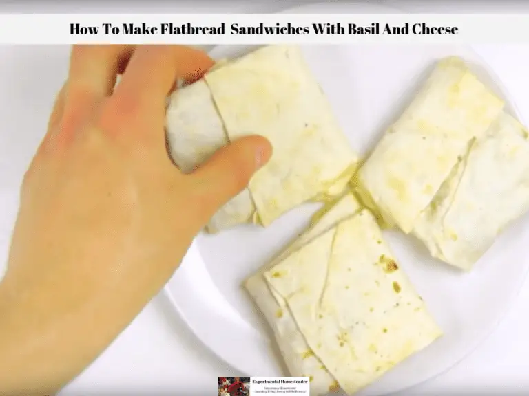 Healthy flatbread sandwiches with basil and cheese being picked up off a plate.