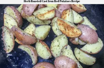 Herb roasted cast iron red potatoes in a cast iron skillet.