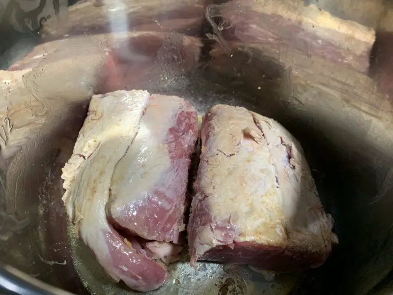 The pork tenderloin being browned in the Instant Pot.