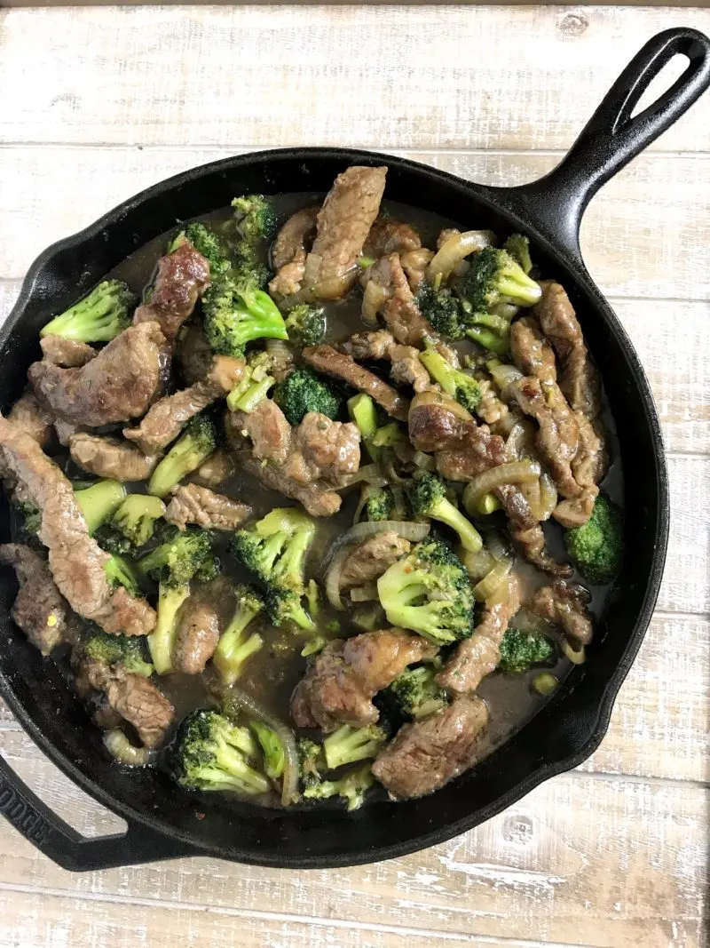 The stir-fry beef and broccoli recipe ready to serve, but still in the cast iron skillet.
