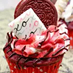 A decorated ready to eat red velvet cupcake.