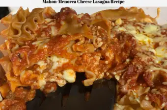 A slice of this cooked cheese lasagna being lifted out of the pan.