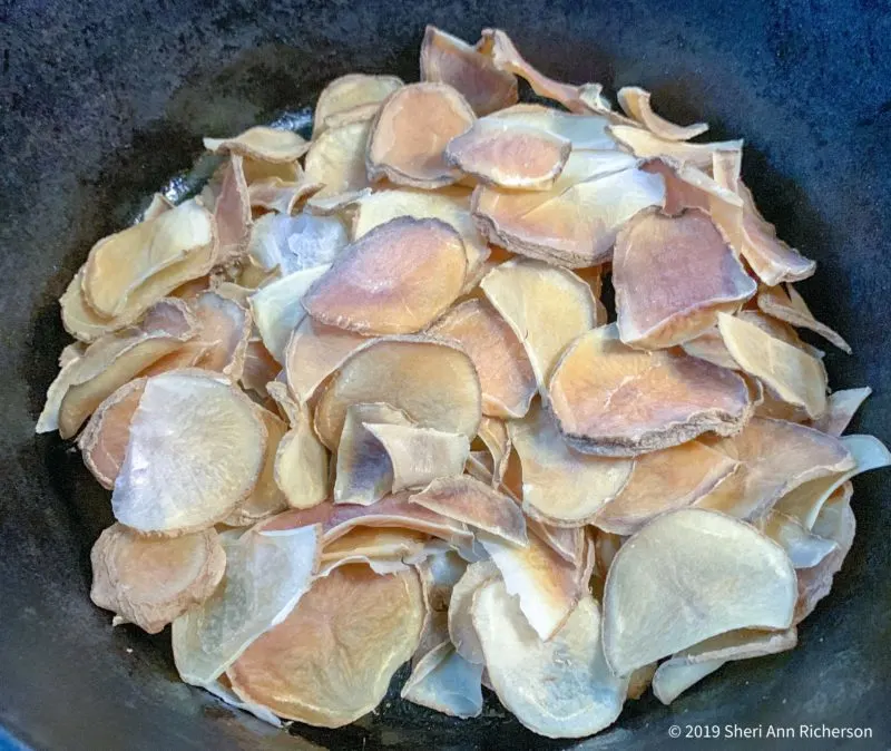 The dehydrated potatoes in the cast iron skillet.