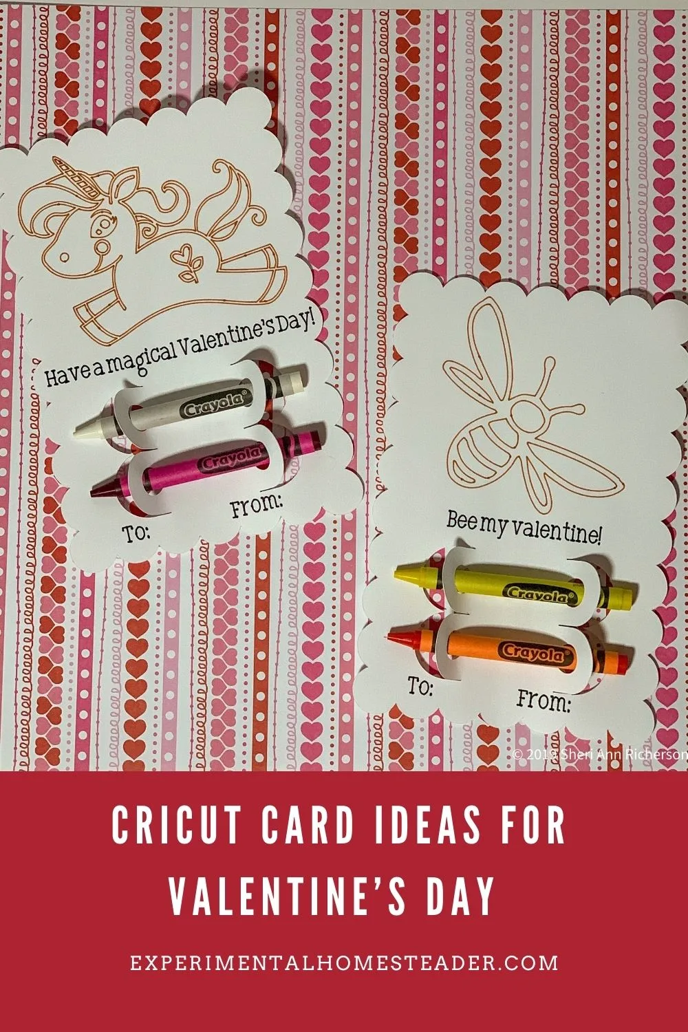 A photo featuring Valentine’s Day-themed Cricut cards with whimsical designs, including a unicorn and a bee. Each card includes a colorful Crayola crayon as part of the design. The text on the cards reads "Have a magical Valentine’s Day!" and "Bee my Valentine." The background has a pink and red heart-patterned design. 