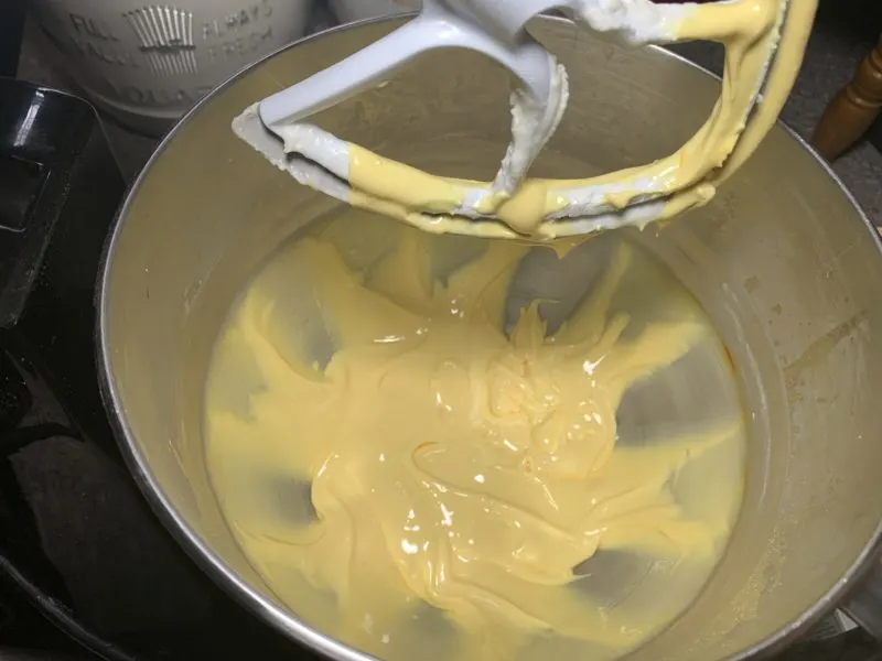 The Royal Icing being tinted yellow.