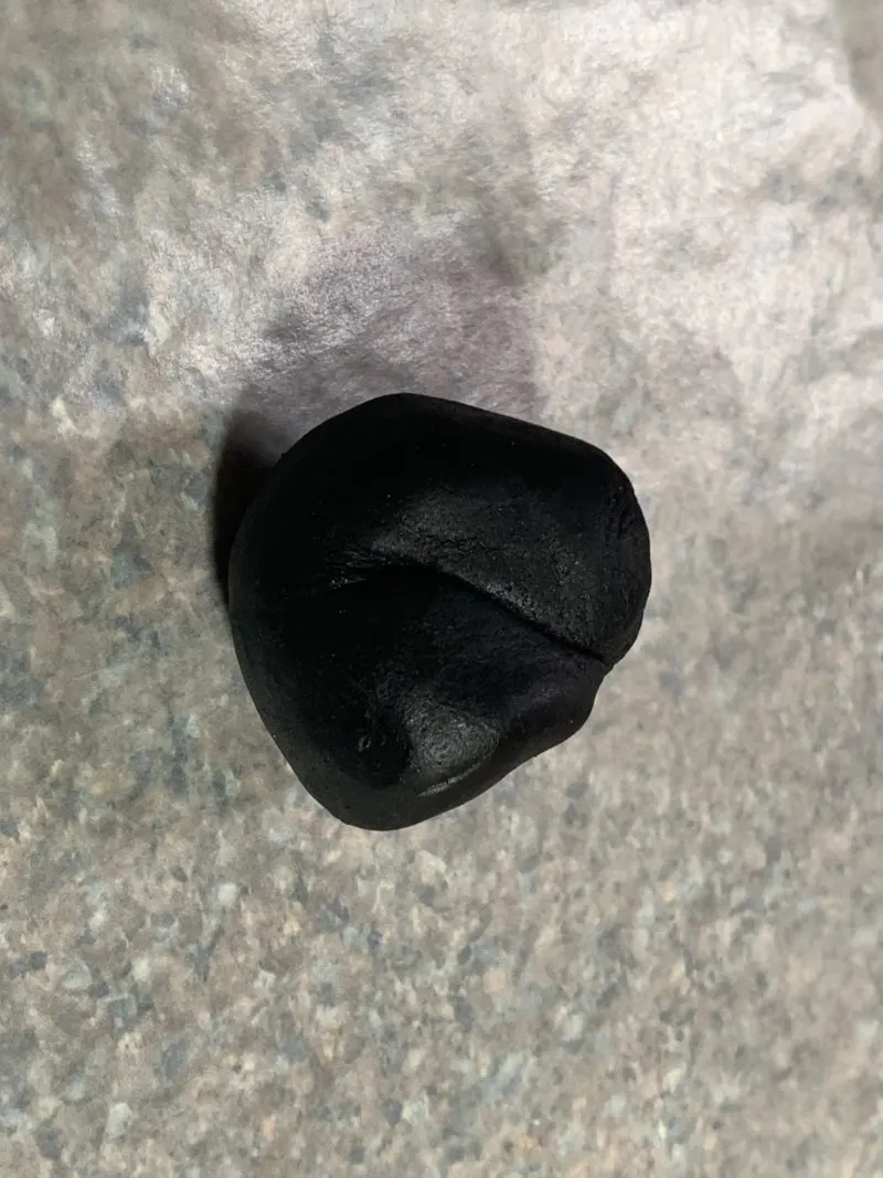 The black fondant rolled into a ball.