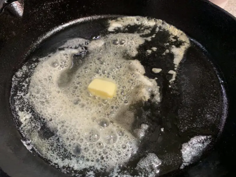 The butter melting in the cast iron skillet.