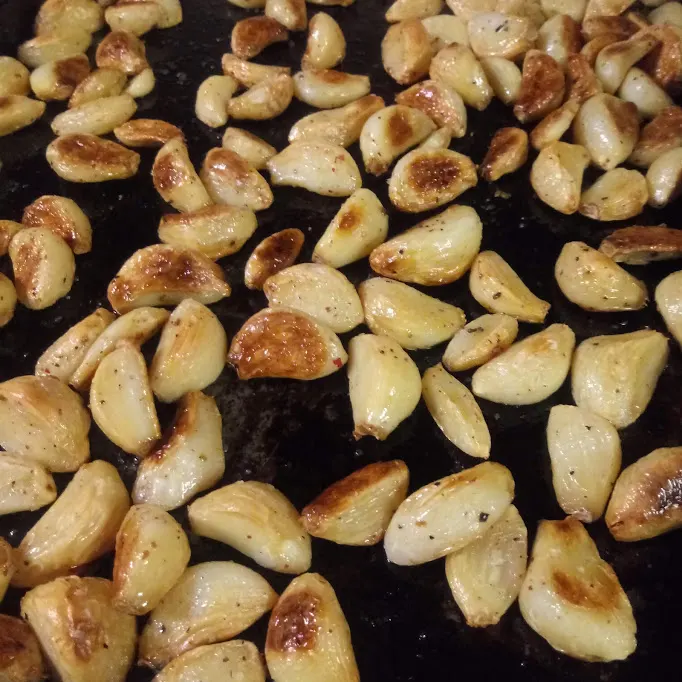 The roasted garlic cloves on the cookie sheet.